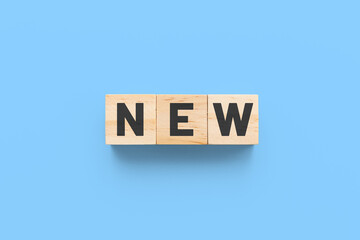 New wooden cubes on blue background