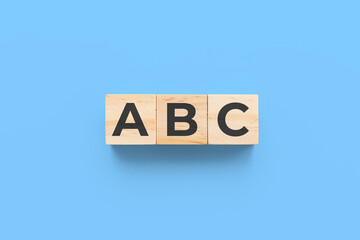 ABC wooden cubes on blue background