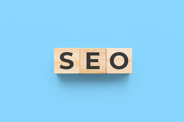 SEO (search engine optimization) wooden cubes on blue background