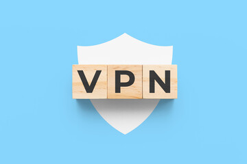 VPN (Virtual Private Network) wooden cubes on blue background with white shield icon