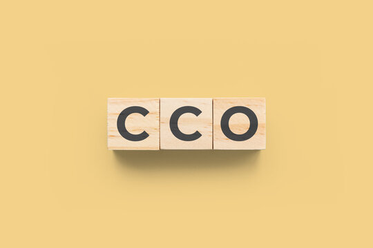 CCO (Chief Communications Officer) wooden cubes on yellow background
