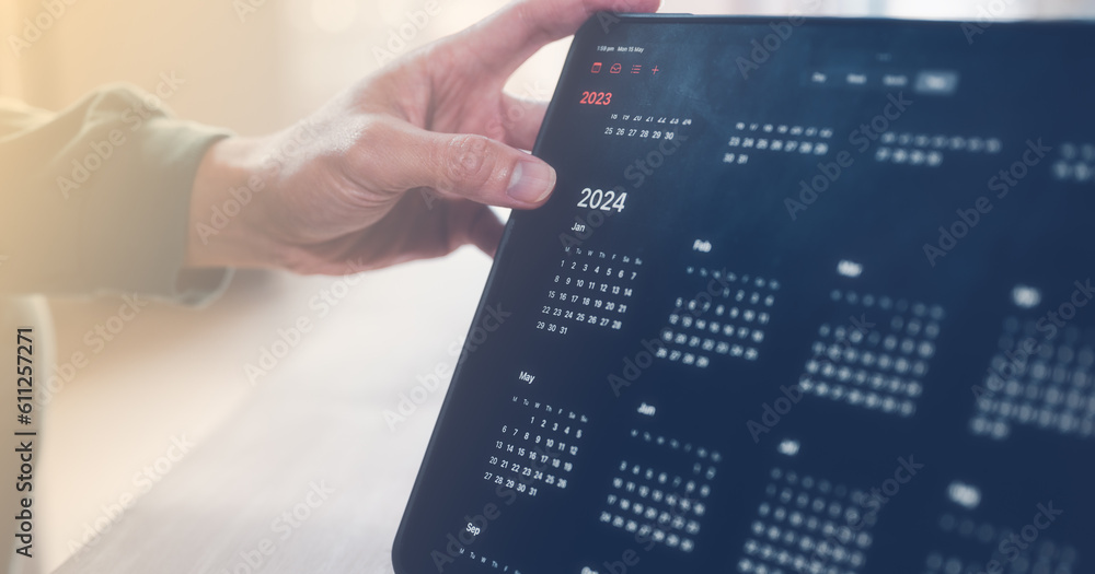 Poster concept of time management financial planning and reminder for 2024. man using computer tablet worki