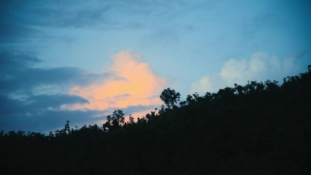 Orange cloud behind a jungle hill in the Philippines