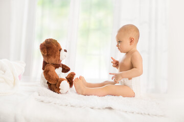 Baby playing with soft toy