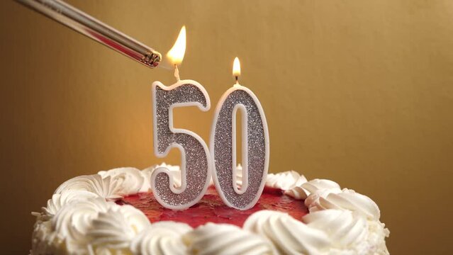 A candle in the form of the number 50 is lit, which is stuck into the holiday cake. Celebrating a birthday or a landmark event. The climax of the celebration.