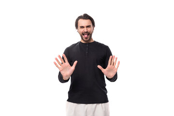 Fototapeta premium young confused handsome brunet european man in black sweatshirt on isolated white background