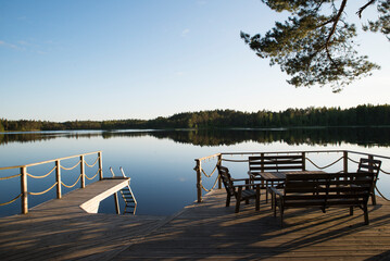 Beautiful wooden balcony on a lake in Sweden. Peace and relax at sunset. Holiday destination