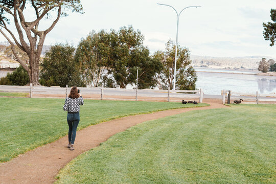 Woman walking to lake Dulverton in Oatlands, Tasmania, Australia