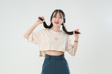 Portrait isolated cutout studio shot of Asian young cute female teenage fashion model with pigtails...