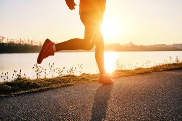 Woman running outdoors. Healthy lifestyle concept, people go in sports. Silhouette family at sunset. Health care, authenticity, sense of balance and calmness.	