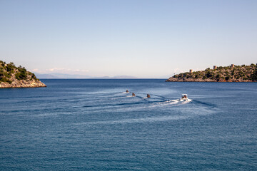 Obraz premium Speedboats accelerating out of a bay in the Ionian