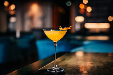 alcoholic cocktail in a glass stands on a table in a bar or restaurant