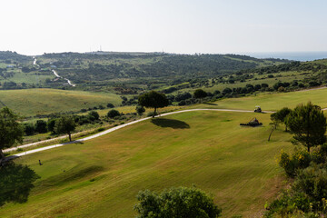 Obraz premium Golf course landscape, Spain. Picturesque scenery golf course green field with trees. Province of Alicante, Spain. Sport and lifestyle concept.