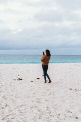 Fototapeta na wymiar Woman on the Sandy Beaches of Taylors Beach in Tasmania