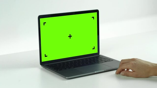 Empty Green Screen Display Laptop Swipe Left Double on a White Background. Green Mock-up Monitor for Video Call, Website Template Presentation or Game Applications. Blank Screen Monitor 3D render.