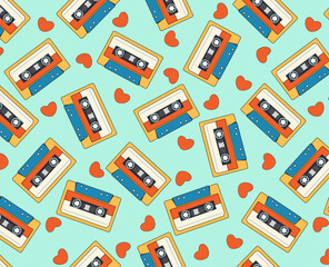 Seamless vector pattern with 90s audio cassettes. Retro audio cassette and hearts. Hand drawn vector cartoon in simple style. Green background.