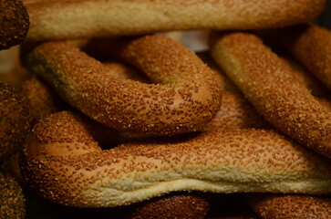 Bagel with sesame. Bagel with poppy. Showcase of a bakery in the eastern market. Turkish Simit.