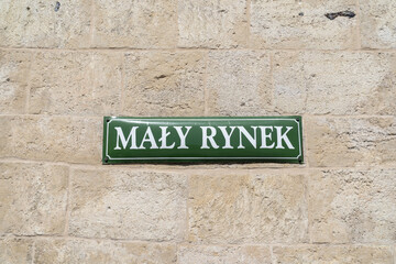 Mały Rynek street name sign in the Old Town district of Krakow, Poland. Information plate on...