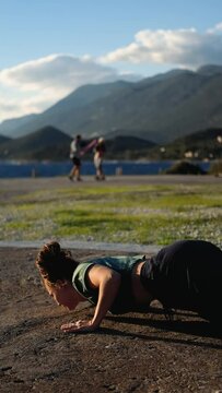 vertical video, a woman in a yoga pose against the backdrop of mountains and boxing training
