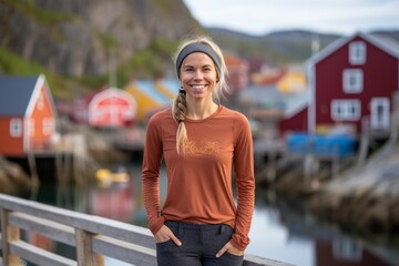 Lifestyle portrait photography of a grinning girl in her 30s wearing a versatile pair of leggings against a picturesque fishing village background. With generative AI technology