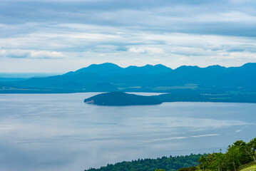 Lake Kussharo in summer season sunny day. Natural landscape from Bihoro-toge pass lookout view point. Akan Mashu National Park, Hokkaido, Japan