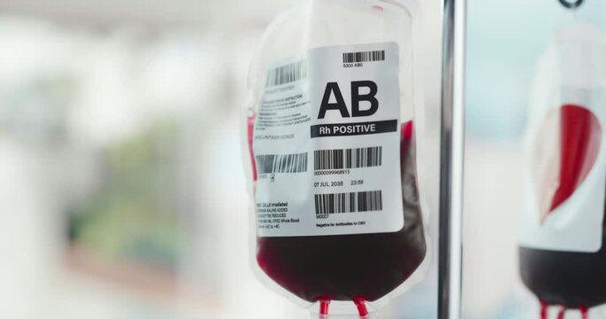 Close Up Shot Of Two Blood Bags From Donor Hanging On The Stand In Donation Center Or Hospital. Concept Of Saving Lives of Patients Who Require Blood Transfusion After Organ Transplantation.