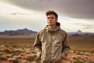 Lifestyle portrait photography of a satisfied boy in his 30s wearing a lightweight windbreaker against a picturesque desert oasis background. With generative AI technology