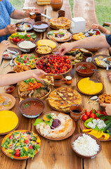 Homemade Romanian Food with grilled meat, polenta and vegetables Platter on camping. Romantic traditional moldavian food outside on the wood table.
