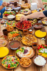 Homemade Romanian Food with grilled meat, polenta and vegetables Platter on camping. Romantic traditional moldavian food outside on the wood table.