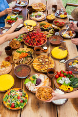 Homemade Romanian Food with grilled meat, polenta and vegetables Platter on camping. Romantic traditional moldavian food outside on the wood table.