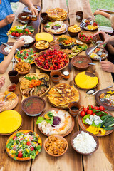 Homemade Romanian Food with grilled meat, polenta and vegetables Platter on camping. Romantic traditional moldavian food outside on the wood table.