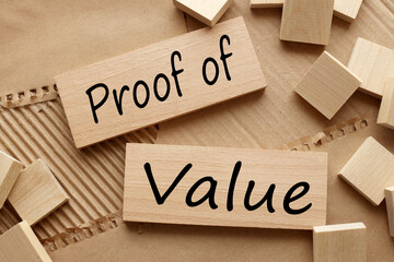 Proof of value text on wooden blocks. brown background