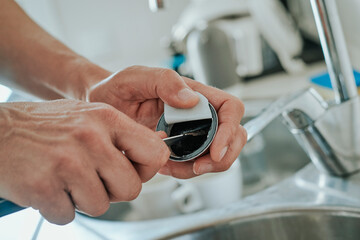 man emptying a coffee capsule
