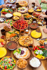 Homemade Romanian Food with grilled meat, polenta and vegetables Platter on camping. Romantic traditional moldavian food outside on the wood table.