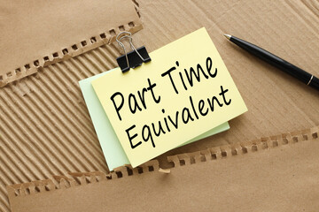 PTE Part time equivalent symbol. text on yellow sticky note on brown background. Business concept.