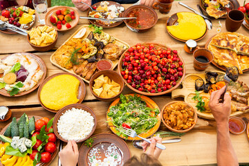 Homemade Romanian Food with grilled meat, polenta and vegetables Platter on camping. Romantic traditional moldavian food outside on the wood table.