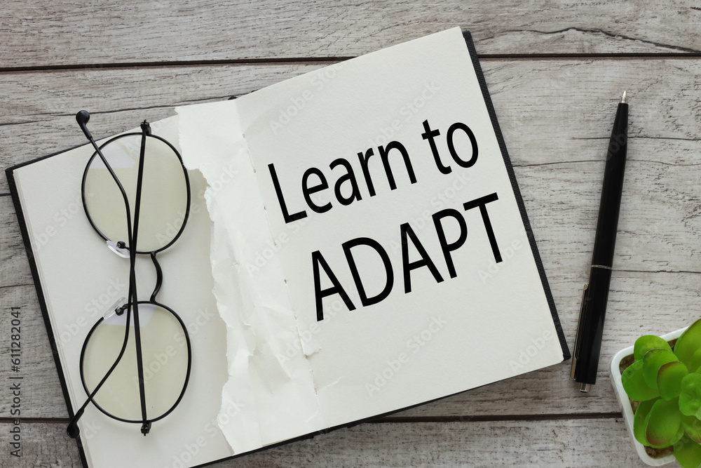 Poster learn to adapt notepad with text. glasses on a notebook page.