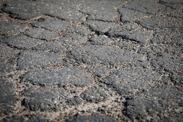 Asphalt road texture background. Damaged, cracked and pitted