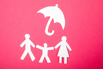 Health and safety in the family. Paper human figures on a pink background