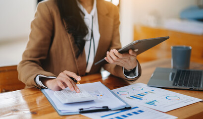 Close up of businesswoman or accountant hand typing laptop working to calculate on desk about cost at office.