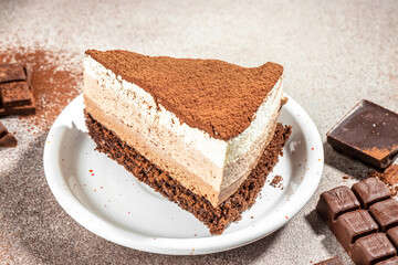 a piece of cake, three of chocolate on a light background, place for text