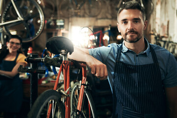Plakat Serious, portrait and technician man in bicycle shop working in store or cycling workshop for repair. Face, bike mechanic and confident male person, business owner or mature professional with pride