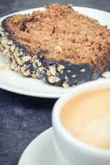 Zucchini dough on plate and cup of white coffee. Delicious dessert