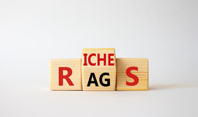 Rags vs Riches symbol. Wooden cubes with words Rags and Riches. Beautiful white background. Rags vs Riches and business concept. Copy space