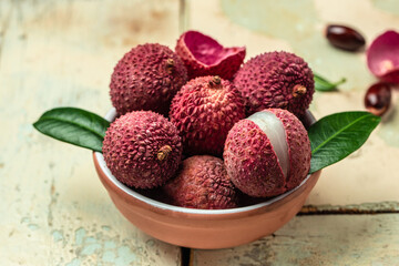 Ripe lychee. Exotic asian fruits in bowl on plate on a light background, top view