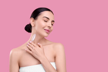 Beautiful woman with smear of body cream on her neck against pink background, space for text