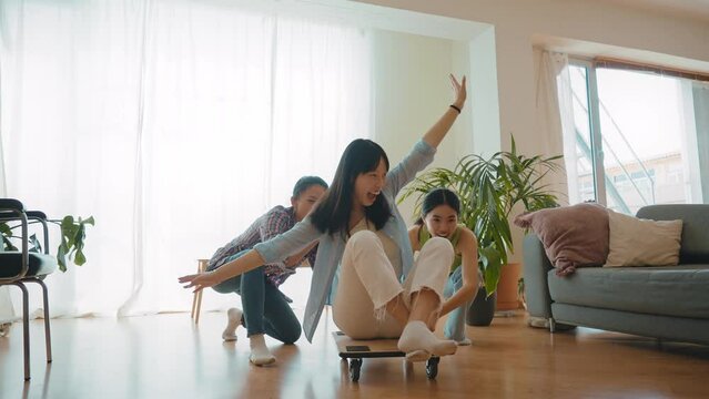 Group of female friends enjoying life and having fun at home. Girls day in the apartment. Young women spending time together chatting and making activities in the living room. Concept about lifestyle