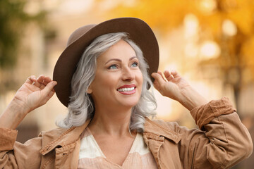 Portrait of smiling woman with ash hair color outdoors