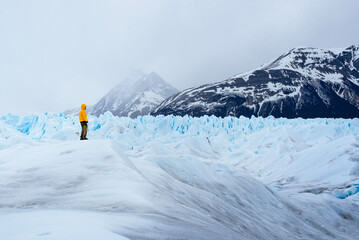 A man posing on the ice formation of the Perito Moreno glacier, Argentina