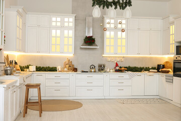 Cozy spacious kitchen decorated for Christmas. Interior design